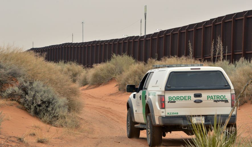 In this Jan. 4, 2016, file photo, a U.S. Border Patrol agent drives near the U.S.-Mexico border fence in Santa Teresa, N.M. (AP Photo/Russell Contreras)