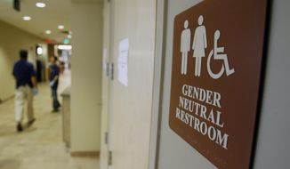 FILE- In this Aug. 23, 2007, file photo, a sign marks the entrance to a gender-neutral restroom at the University of Vermont in Burlington, Vt. (AP Photo/Toby Talbot, File)