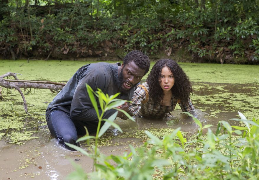 This image released by WGN shows Aldis Hodge, left, and Jurnee Smollett-Bell in a scene from "Underground," a new drama series premiering on WGN America on Wednesday at 10 p.m. EDT. (Skip Bolen/Sony Pictures Television via AP)