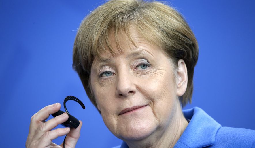 German Chancellor Angela Merkel holds her earphone during a joint press conference after a meeting with UN Secretary-General, Ban Ki-moon, at the Chancellery in Berlin, Germany, Tuesday, March 8, 2016. (AP Photo/Michael Sohn)