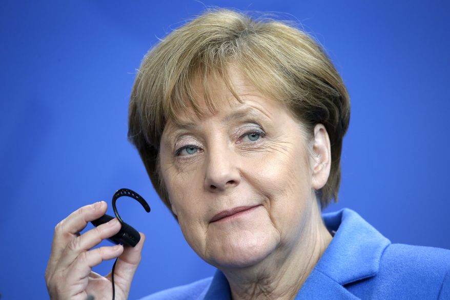 German Chancellor Angela Merkel holds her earphone during a joint press conference after a meeting with UN Secretary-General, Ban Ki-moon, at the Chancellery in Berlin, Germany, Tuesday, March 8, 2016. (AP Photo/Michael Sohn)