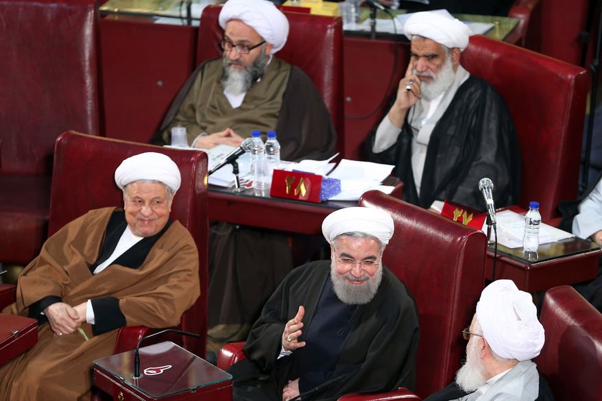 CORRECTS DAY TO TUESDAY - Iranian President Hassan Rouhani, bottom center, who is also a member of the Assembly of Experts, attends the last seasonal meeting of the fourth assembly in Tehran, Iran, Tuesday, March 8, 2016. The next Assembly of Experts meeting will be held on late May by the new Experts who have won the recent elections. (AP Photo/Ebrahim Noroozi)