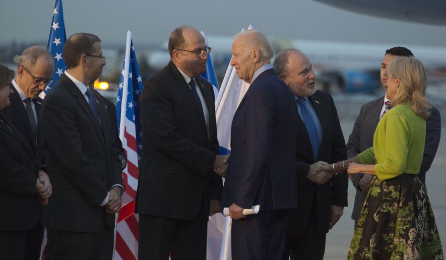 U.S. Vice President Joe Biden shakes hands with Israel Defense Minister Moshe Ya&#39;alon, left, fter arriving at Ben Gurion Airport in Lod, Israel on Tuesday, March 8, 2016. (Heidi Levine/Pool photo via AP)