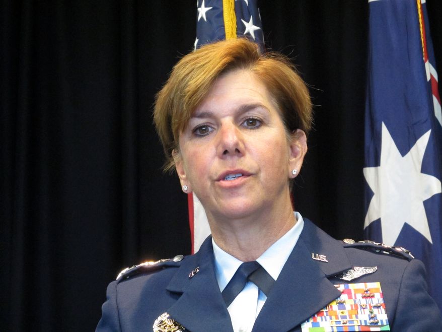 Gen. Lori Robinson, the commander of the Pacific Air Forces, talks to reporters Tuesday, March 8, 2016, at the U.S. Embassy in Canberra, Australia. She said the U.S. Air Force will continue to fly daily missions over the South China Sea despite a buildup of Chinese surface-to-air missiles and fighter jets in the contested region. (AP Photo/Rod McGuirk)