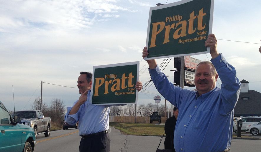 Kentucky Gov. Matt Bevin, left, campaigns with Republican House candidate Phillip Pratt in Georgetown, Ky., Monday, March 7, 2016. Voters on Tuesday are electing four state representatives in a series of special elections created by resignations and two strategic appointments by new Republican Gov. Matt Bevin. (AP Photo/Adam Beam)