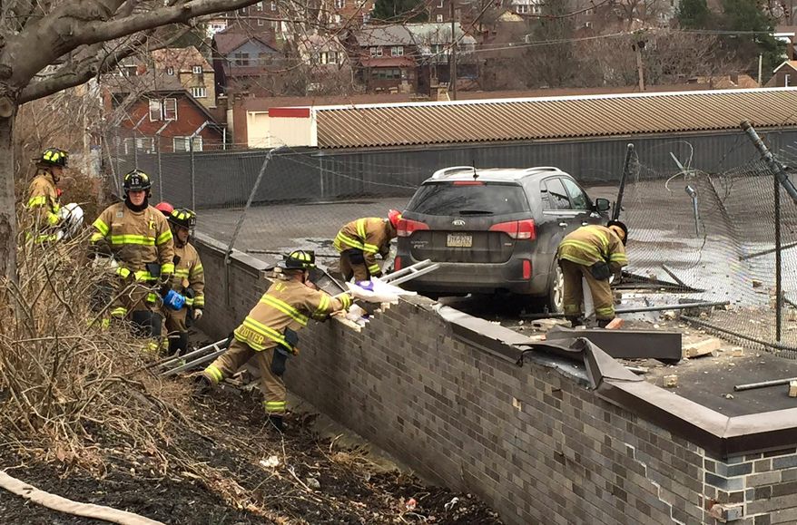 Emergency personnel check a vehicle that crashed onto the roof of a supermarket, Tuesday, March 8, 2016, in Pittsburgh. The crash happened late Tuesday morning at a Giant Eagle store in the city’s Greenfield neighborhood. (Darrell Sapp/Pittsburgh Post-Gazette via AP) PITTSBURGH OUT, GREENSBURG OUT, TARENTUM OUT, MONESSEN OUT. NO ARCHIVES, NO SALES, NO TV, NO INTERNET, NO MAGS