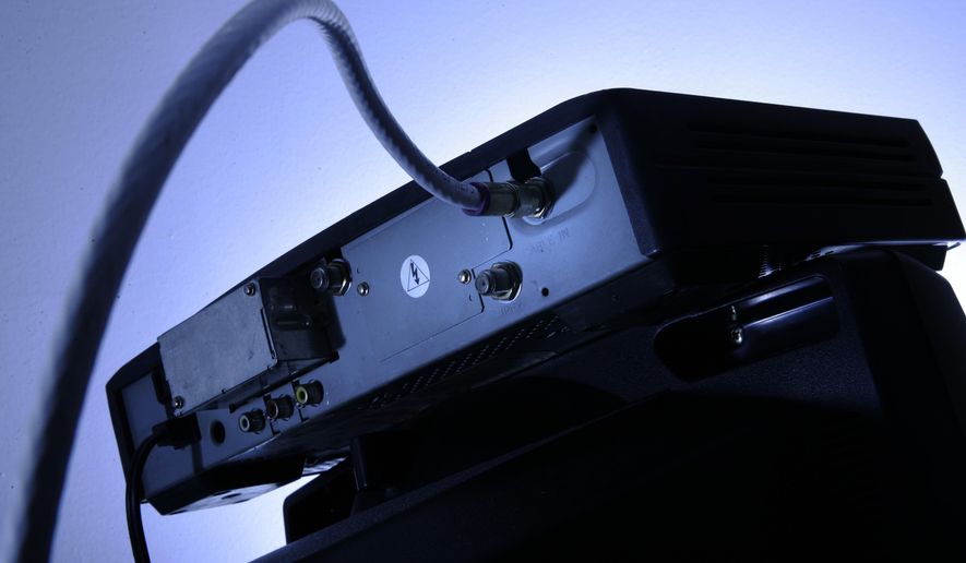 FILE - This Wednesday, May 30, 2007, file photo shows a cable box on top of a television in Philadelphia. Cable boxes may not be very exciting, but they’re emerging as a new battleground over the future of TV. Technology companies and the government want to open up the boxes to new services and programming. Cable companies want to keep control in their own hands. The outcome could affect what you pay for television and whether you’ll still need to clutter your entertainment center with multiple boxes attached to your TV. (AP Photo/Matt Rourke, File)