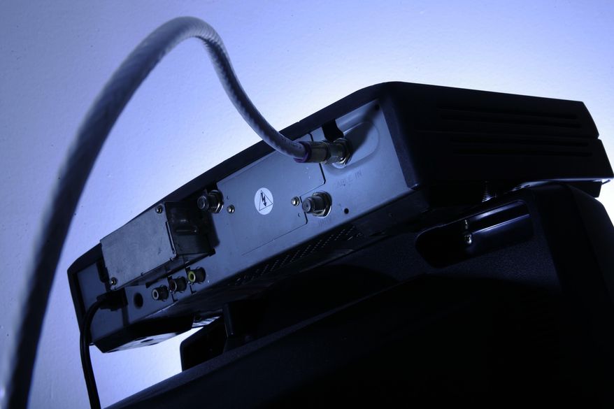 FILE - This Wednesday, May 30, 2007, file photo shows a cable box on top of a television in Philadelphia. Cable boxes may not be very exciting, but they’re emerging as a new battleground over the future of TV. Technology companies and the government want to open up the boxes to new services and programming. Cable companies want to keep control in their own hands. The outcome could affect what you pay for television and whether you’ll still need to clutter your entertainment center with multiple boxes attached to your TV. (AP Photo/Matt Rourke, File)