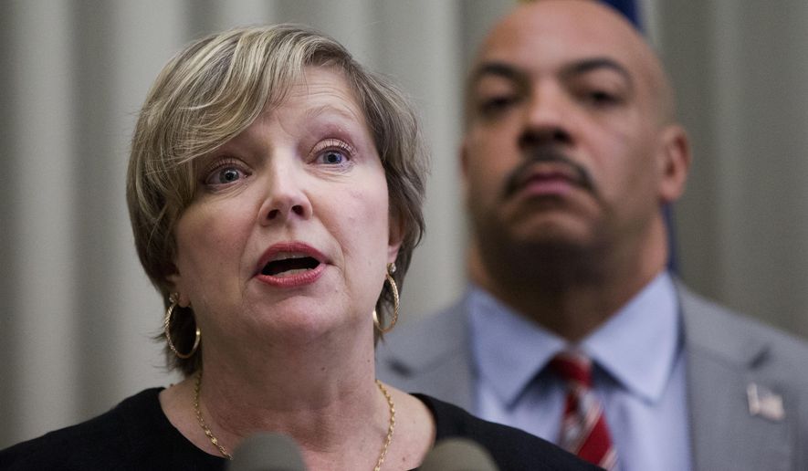Dawn Holtz, Assistant Chief of the Insurance Fraud Unit in the Philadelphia District Attorney's Office accompanied by Philadelphia District Attorney Seth Williams speaks with members of the media during a news conference Wednesday, March 9, 2016, in Philadelphia. Williams said a city fleet supervisor steered work to a South Philadelphia auto body shop that overcharged the city about $400,000 for phony or inflated bills. (AP Photo/Matt Rourke)