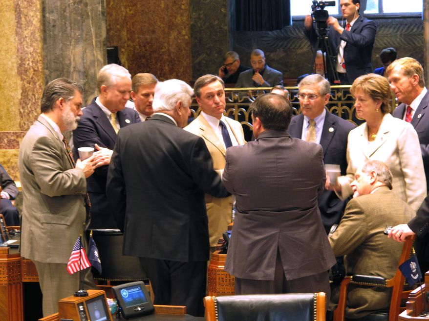 Senators meet with Senate President John Alario, R-Westwego, on the Senate floor ahead of the voting on the final day of a special legislative session on the budget and taxes, on Wednesday, March 9, 2016, in Baton Rouge, La. (AP Photo/Melinda Deslatte)