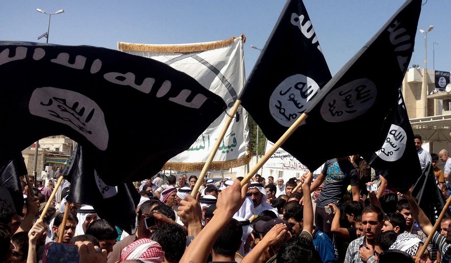 Demonstrators chant pro-Islamic State slogans as they wave the group&#39;s flags in front of the provincial government headquarters in Mosul, Iraq, on June 16, 2014. (Associated Press) **FILE**