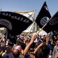 Demonstrators chant pro-Islamic State slogans as they wave the group&#x27;s flags in front of the provincial government headquarters in Mosul, Iraq, on June 16, 2014. (Associated Press) **FILE**