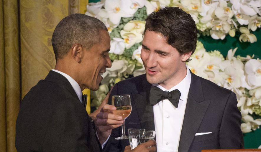 Canadian Prime Minister Justin Trudeau, right, proposes a toast to U.S. President Barack Obama during a state dinner Thursday, March 10, 2016, in Washington. (Paul Chiasson/The Canadian Press via AP) ** FILE **