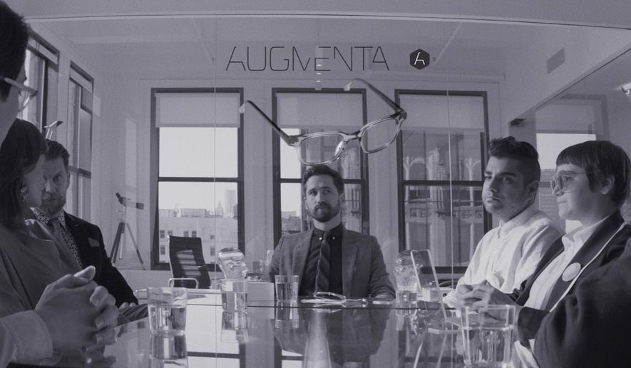 This image released by Magnolia Pictures shows Benjamin Dickinson, center, in a scene from the film, "Creative Control." The film is about an ad exec who gets lost in the possibilities of Augmenta, an augmented reality system in a pair of glasses. (Magnolia Pictures via AP)