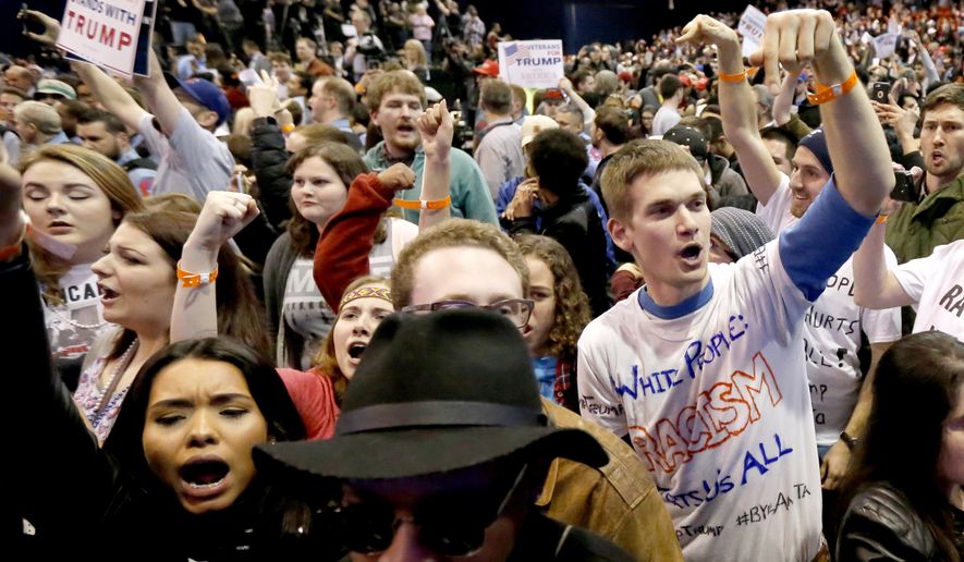 Protesters of Republican presidential candidate Donald Trump, right, chant after a rally on the campus of the University of Illinois-Chicago, was canceled due to security concerns Friday, March 11, 2016, in Chicago. (AP Photo/Charles Rex Arbogast)