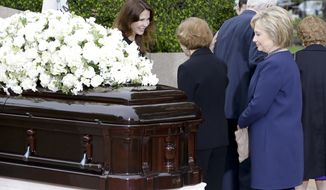 Patti Davis, left, greets Rosalynn Carter as Hillary Clinton looks at the casket during the graveside service for Nancy Reagan at the Ronald Reagan Presidential Library, Friday, March 11, 2016 in Simi Valley, Calif. (AP Photo/Chris Carlson)