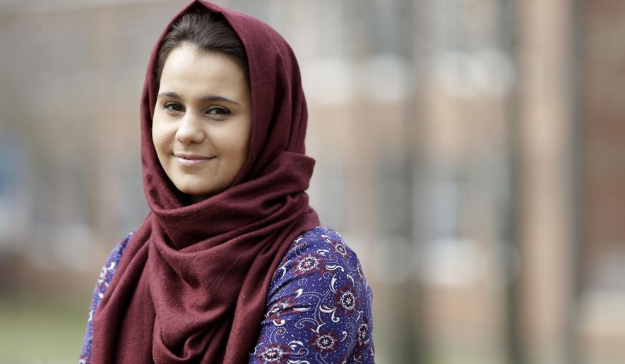 Hina Naveed poses for a picture at her school, the College of Staten Island, in New York, Thursday, March 10, 2016. The state board that licenses doctors and dentists and certifies teachers has voted to allow some undocumented immigrants who have met all other educational criteria to be allowed to apply for their licenses. (AP Photo/Seth Wenig)