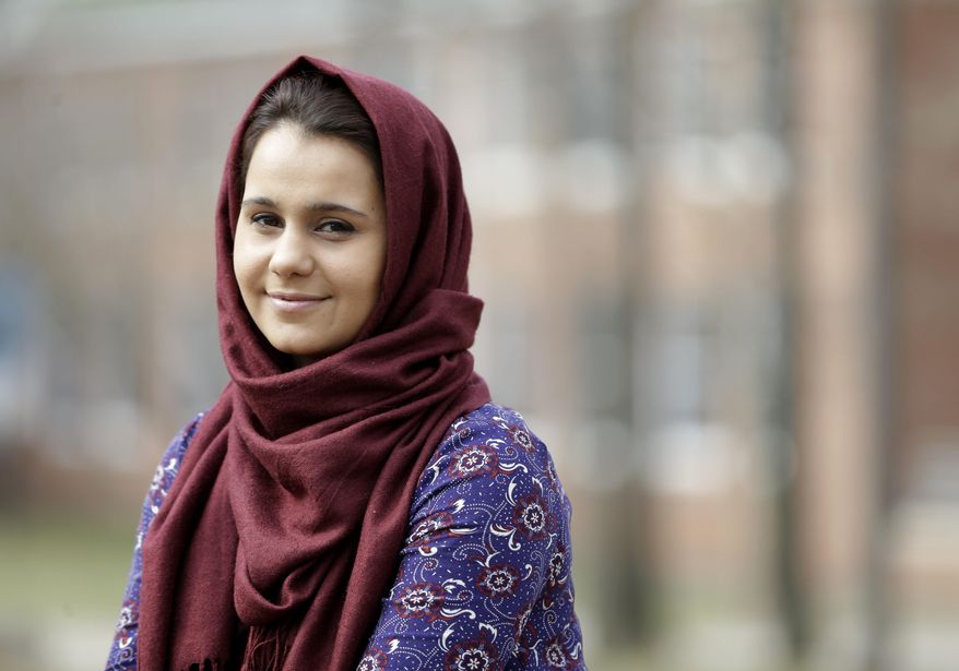 Hina Naveed poses for a picture at her school, the College of Staten Island, in New York, Thursday, March 10, 2016. The state board that licenses doctors and dentists and certifies teachers has voted to allow some undocumented immigrants who have met all other educational criteria to be allowed to apply for their licenses. (AP Photo/Seth Wenig)