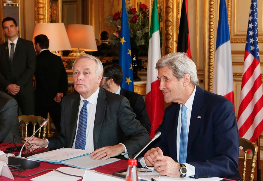 French Foreign Minister Jean Marc Ayrault, left, and United States Secretary of State John Kerry, attend a meeting at the Quai d'Orsay ministry in Paris, Sunday, March 13, 2016. U.S. Secretary of State John Kerry is meeting with new French Foreign Minister Jean-Marc Ayrault and Europe's top diplomats to discuss major international issues including the Syria peace talks. (Gonzalo Fuentes/Pool Photo via AP)