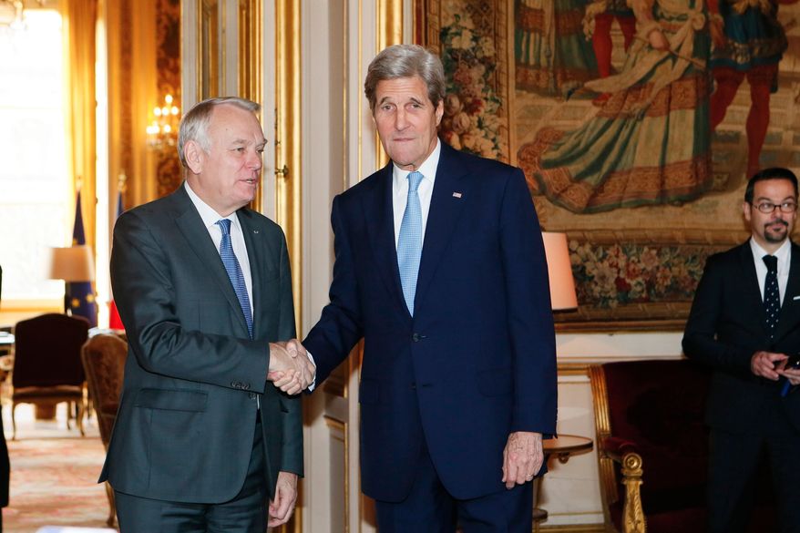 French Foreign Minister Jean Marc Ayrault, left, shakes hand with United States Secretary of State John Kerry, prior to a meeting at the Quai d'Orsay ministry in Paris, Sunday, March 13, 2016. U.S. Secretary of State John Kerry is meeting with new French Foreign Minister Jean-Marc Ayrault and Europe's top diplomats to discuss major international issues including the Syria peace talks.(Gonzalo Fuentes/Pool Photo via AP)