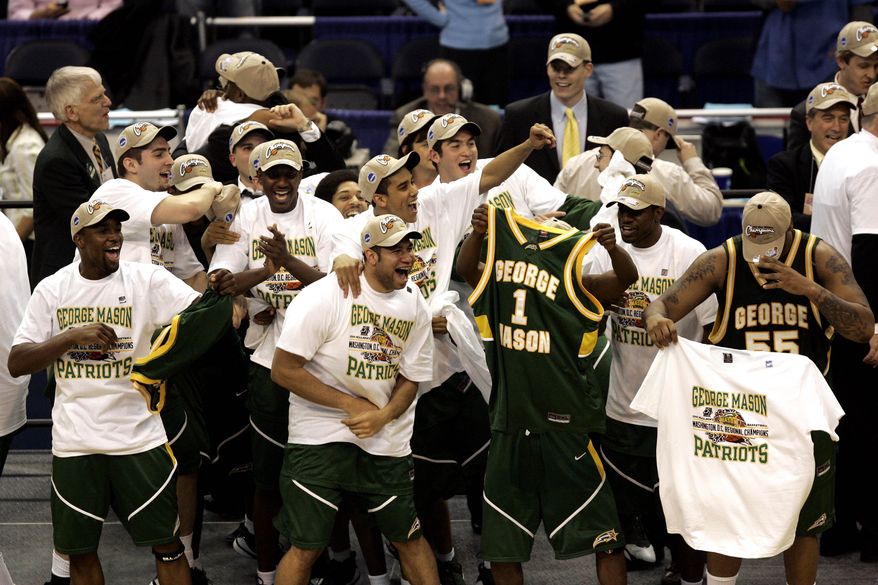 George Mason players celebrate their 86-84 overtime victory over Connecticut during the fourth round game of the NCAA basketball tournament in Washington, Sunday, March 26, 2006. (AP Photo/Susan Walsh)