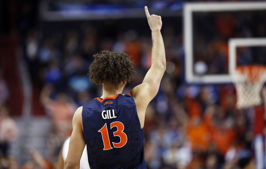 Virginia forward Anthony Gill (13) signals to teammates during the second half of an NCAA college basketball game in the championship of the Atlantic Coast Conference tournament against North Carolina, Saturday, March 12, 2016, in Washington. (AP Photo/Alex Brandon)