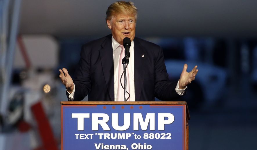 Republican presidential candidate, Donald Trump holds a plane-side rally in a hanger at Youngstown-Warren Regional Airport in Vienna, Ohio, Monday, March 14, 2016. (AP Photo/Gene J. Puskar)