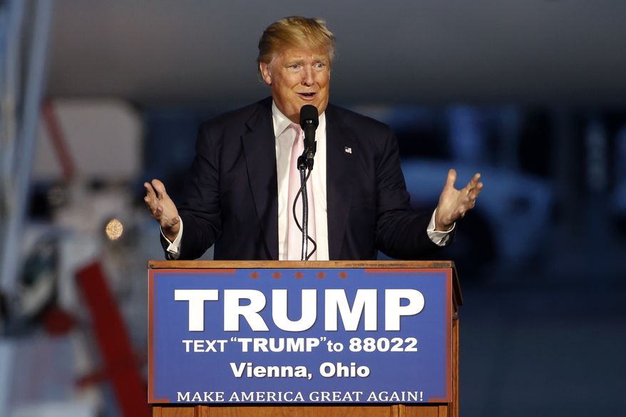 Republican presidential candidate, Donald Trump holds a plane-side rally in a hanger at Youngstown-Warren Regional Airport in Vienna, Ohio, Monday, March 14, 2016. (AP Photo/Gene J. Puskar)