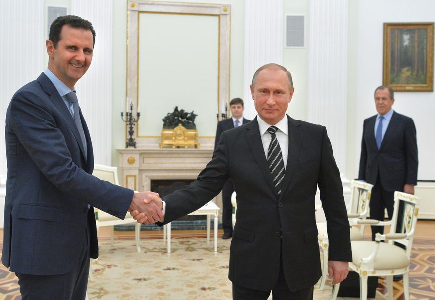 In this file photo taken on Tuesday, Oct. 20, 2015, Russian President Vladimir Putin, center, shakes hand with Syrian President Bashar Assad as Russian Foreign Minister Sergey Lavrov, right, looks on in the Kremlin in Moscow, Russia. (Alexei Druzhinin, Sputnik, Kremlin Pool Photo via AP, File)