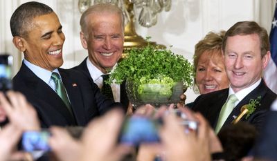 President Barack Obama, left, with Vice President Joe Biden, and Ireland Prime Minister Enda Kenny, right, with his wife Fionnuala Kenny, hold up a bowl of shamrocks during a reception in honor of St. Patrick&#x27;s Day in the East Room of the White House in Washington, Tuesday, March 15, 2016. Obama is celebrating his eighth St. Patrick&#x27;s Day in the White House. (AP Photo/Jacquelyn Martin)