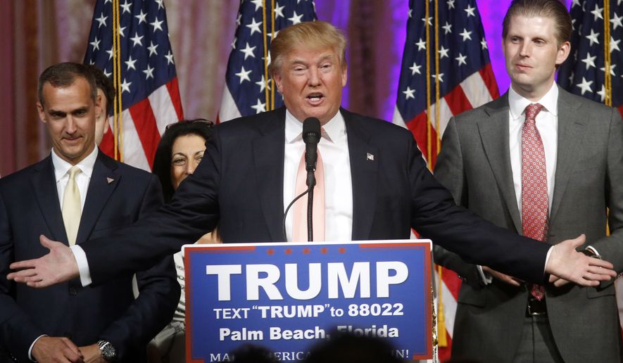 Republican presidential candidate Donald Trump speaks to supporters at his primary election night event at his Mar-a-Lago Club in Palm Beach, Fla., Tuesday, March 15, 2016. At right is his son Eric Trump and at left is campaign manager Corey Lewandowski. (AP Photo/Gerald Herbert)