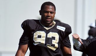 New Orleans Saints outside linebacker Junior Galette (93) jokes around with Greg McMahon Special team&#39;s coordinator during the teams NFL football training camp in White Sulphur Springs, W. Va., Monday, Aug. 3, 2015. (AP Photo/Chris Tilley)
