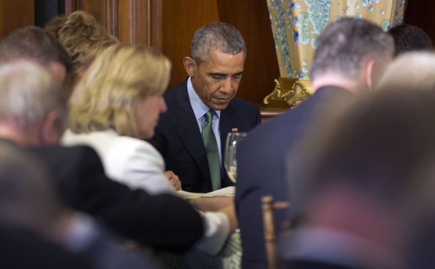 President Barack Obama bows his head during a prayer at a St. Patrick's Day luncheon for Irish Prime Minister Enda Kenny, on Capitol Hill in Washington, Tuesday, March 15, 2016. (AP Photo/Pablo Martinez Monsivais) **FILE**