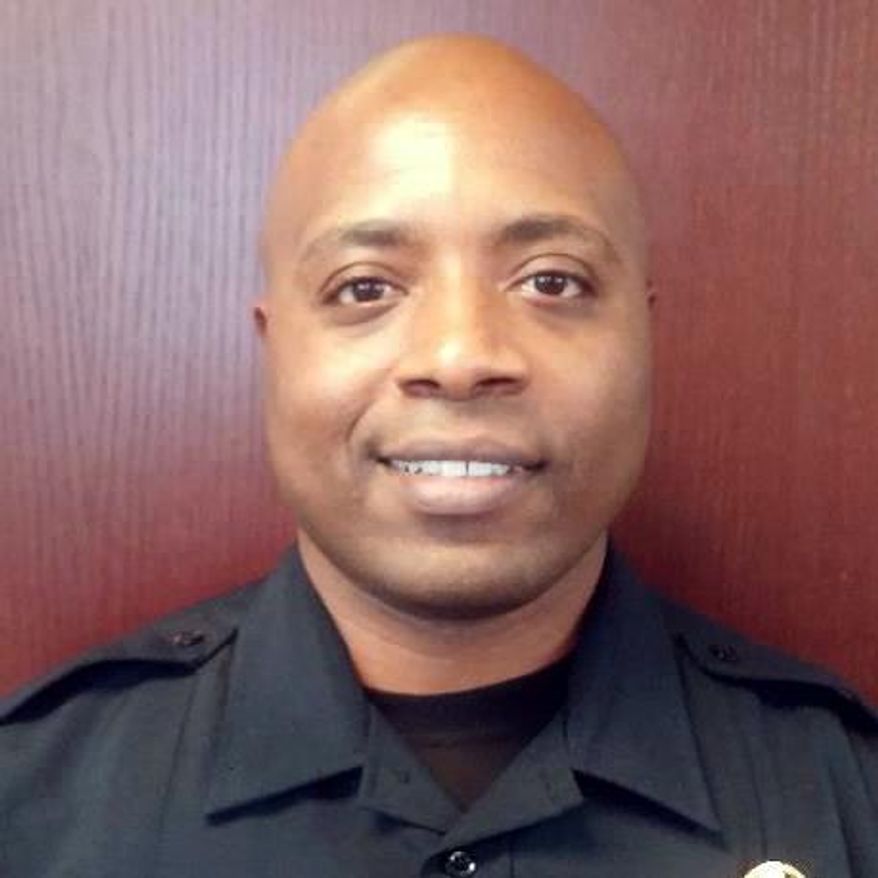 This undated handout photo provided by the Farmers Branch Police Department shows Ken Johnson. Authorities say a 16-year-old from Dallas has been killed and another person is hospitalized after a shooting at a gas station involving an off-duty suburban Dallas police officer. An Addison, Texas spokesman says the preliminary investigation suggests Johnson intervened when he saw a crime in progress. (Farmers Branch Police Department via AP)