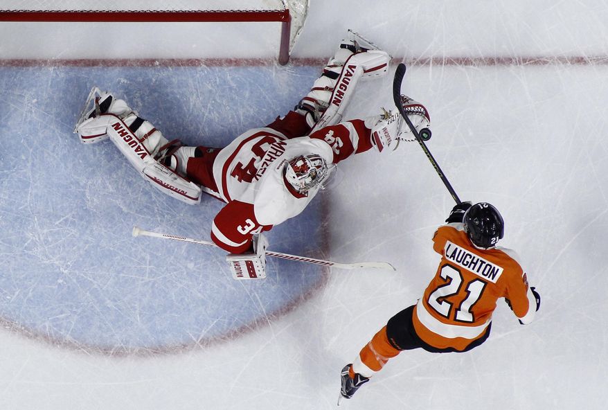 Detroit Red Wings' Petr Mrazek, left, blocks a shot by Philadelphia Flyers' Scott Laughton during the second period of an NHL hockey game, Tuesday, March 15, 2016, in Philadelphia. (AP Photo/Matt Slocum)