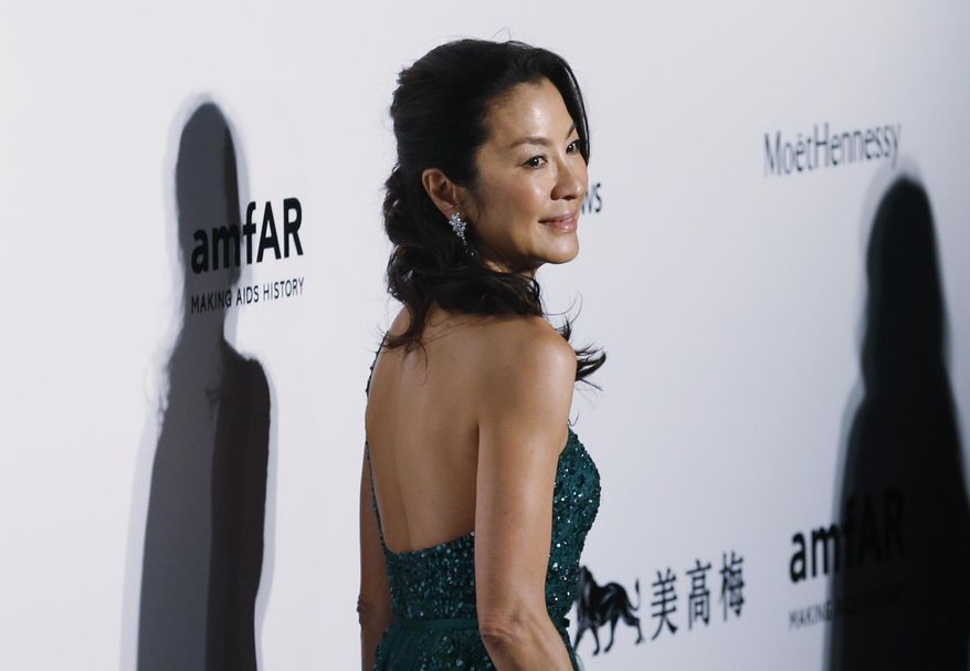 FILE - In this March 14, 2015, file photo, Malaysian actress Michelle Yeoh poses on the red carpet for the fundraising gala organized by amfAR (The Foundation for AIDS Research) in Hong Kong. The United Nations Development Program says it has named Malaysia-born actress Yeoh a Goodwill Ambassador focusing on global development and disaster recovery. (AP Photo/Kin Cheung, File)