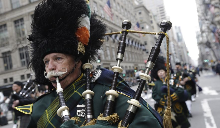 In this March 17, 2015 photo, bagpipers march up Fifth Avenue during the St. Patrick's Day Parade in New York. Tracing its history to 1762, the parade features about 200,000 marchers. (AP Photo/Mary Altaffer, File)