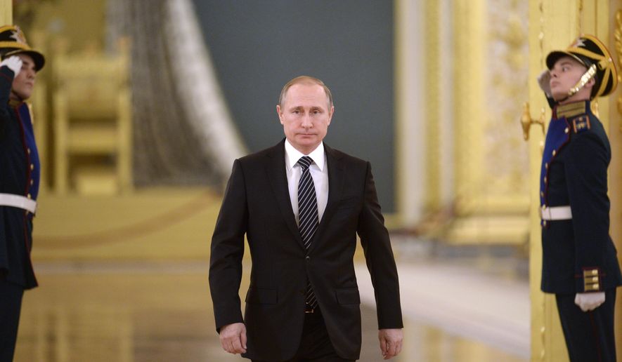 Russian President Vladimir Putin walks in Moscow&#39;s Kremlin, Russia on Thursday, March 17, 2016. President Vladimir Putin says Russia can again build up its forces in Syria “in a few hours” if necessary, and will continue striking extremist groups. Putin made the statement in the Kremlin Thursday while honoring Russian military officers who have taken part in the Syrian campaign. (Alexei Nikolsky/Sputnik, Kremlin Pool Photo via AP)