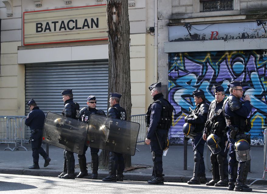 Riot police officers guard the Bataclan concert hall in Paris, Thursday, March 17, 2016. French lawmakers leading an investigation into the Nov. 13 attacks and some of the first responders at the Bataclan concert hall that night returned Thursday to re-enact the horror that left a total of 130 people dead across Paris. (AP Photo/Michel Euler)
