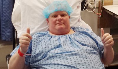 In this Monday, May 11, 2015, file photo provided by Dan Jacobs, former Toronto Mayor Rob Ford gives a thumbs up before surgery in Toronto, to remove a cancerous tumor from his abdomen. On Thursday, March 17, 2016, Ford&#39;s chief of staff, Jacobs, said doctors are working on building his strength to be able to resume chemotherapy. (Courtesy Dan Jacobs via AP)