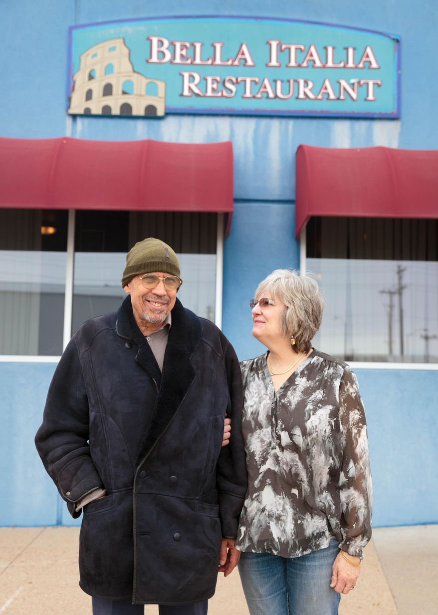 ADVANCE FOR SATURDAY MARCH 19 AND THEREAFTER - In a Feb. 16, 2016 photo, Shadi and Becky Aboushady stand in front of Bella Italia, their Italian restaurant, in Cozad, Neb. Aboushady is trying to sell Bella Italia, their Italian restaurant in Cozad because he has undergone a number of heart surgeries. (Matt Miller/The World-Herald via AP)