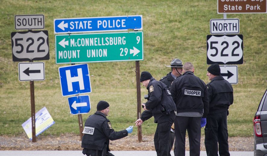 Police investigate at exit 180 off of the Pennsylvania Turnpike, Sunday, March 20, 2016, in Fort Littleton, Pa. A retired state trooper killed a turnpike toll collector and a security guard in a holdup attempt at a toll plaza and then was shot dead by troopers while trying to escape with the money, authorities said. (Daniel Zampogna/PennLive.com via AP)