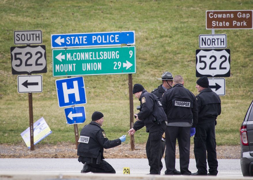 Police investigate at exit 180 off of the Pennsylvania Turnpike, Sunday, March 20, 2016, in Fort Littleton, Pa. A retired state trooper killed a turnpike toll collector and a security guard in a holdup attempt at a toll plaza and then was shot dead by troopers while trying to escape with the money, authorities said. (Daniel Zampogna/PennLive.com via AP)
