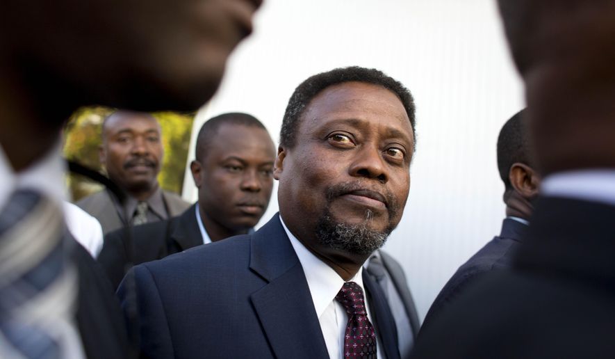 FILE - In this Feb. 26, 2016 file photo, Haiti's new interim Prime Minister Fritz Jean arrives for his induction ceremony at the National Palace in Port-au-Prince, Haiti. A majority of lower house lawmakers rejected Jean for prime minister on Sunday, March 20, 2016, leaving the interim government in limbo. Jean is an economist and former governor of Haiti's central bank. (AP Photo/Dieu Nalio Chery, File)