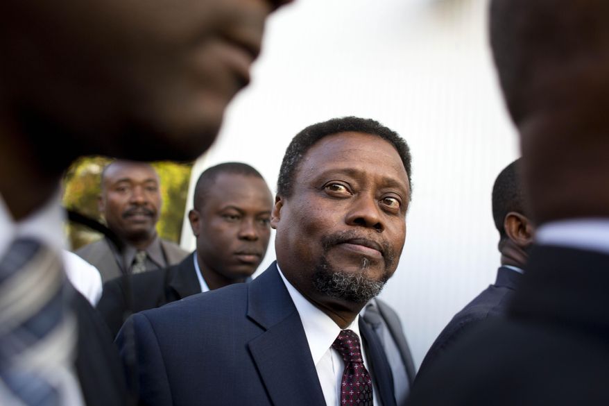 FILE - In this Feb. 26, 2016 file photo, Haiti's new interim Prime Minister Fritz Jean arrives for his induction ceremony at the National Palace in Port-au-Prince, Haiti. A majority of lower house lawmakers rejected Jean for prime minister on Sunday, March 20, 2016, leaving the interim government in limbo. Jean is an economist and former governor of Haiti's central bank. (AP Photo/Dieu Nalio Chery, File)