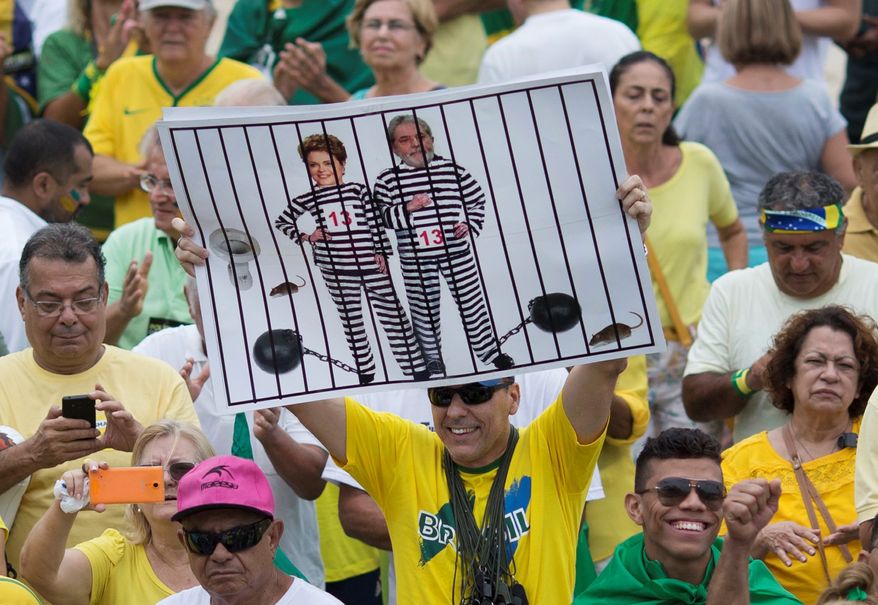 Protesters last week in Rio de Janeiro suggested that Brazilian President Dilma Rousseff and former President Luiz Inacio Lula da Silva belong in prison stripes. (Associated Press)