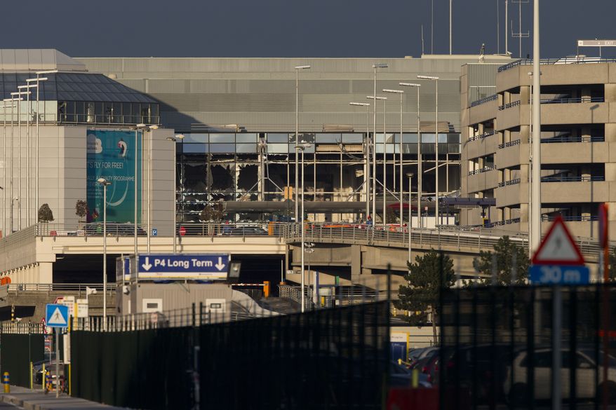 The setting sun strikes the terminal and its blown out windows at Zaventem airport, one of the sites of two deadly attacks in Brussels, Belgium, Tuesday, March 22, 2016. Authorities in Europe have tightened security at airports, on subways, at the borders and on city streets after the attacks Tuesday on the Brussels airport and its subway system. (AP Photo/Peter Dejong)