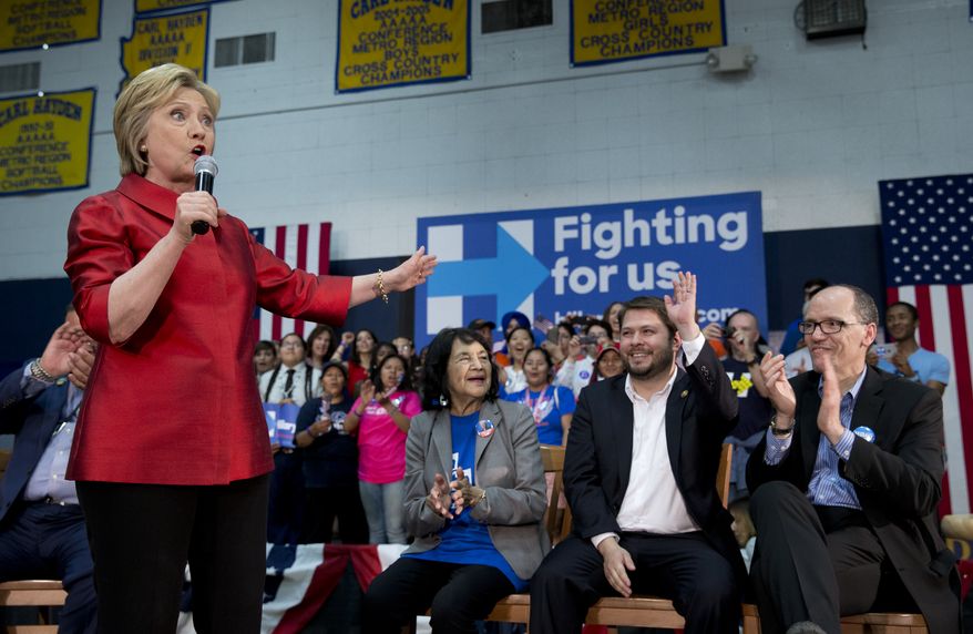 Democratic presidential candidate Hillary Clinton, joined by from left labor leader Dolores Huerta, and Rep. Ruben Gallego, D-Ariz., and Labor Secretary Thomas Perez, speaks during a campaign event at Carl Hayden Community High School in Phoenix, Monday, March 21, 2016. (AP Photo/Carolyn Kaster)