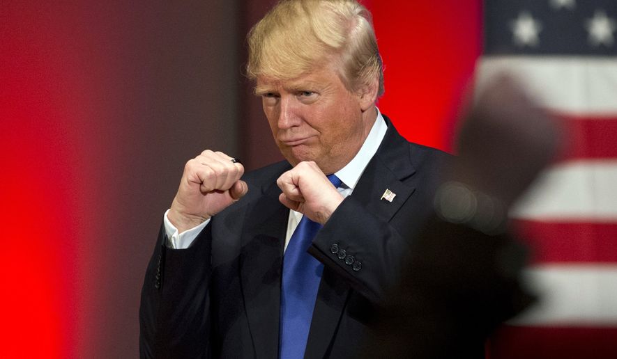 In this Jan. 28, 2016, photo, Republican presidential candidate Donald Trump poses with a ring given to him by a group of veterans during a campaign event on the campus of Drake University in Des Moines, Iowa. For some Americans, the promise of political change and disruption has come too slowly, or failed altogether. On the eve of the first voting contest in the 2016 presidential election, these voters are pushing for bolder, more uncompromising action, with an intensity that has shaken both the Republican and Democratic establishment. (AP Photo/Jae C. Hong)