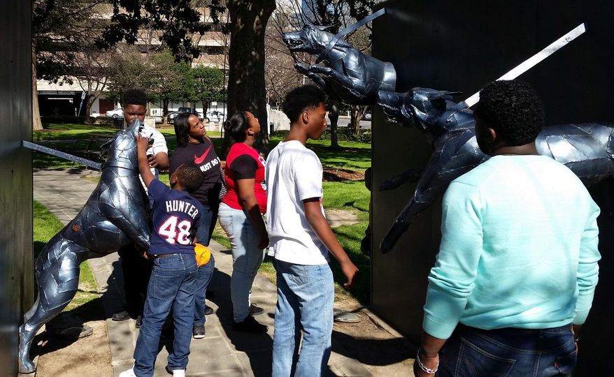 The Padgett family of Meridian, Miss., looks at a civil rights sculpture in Birmingham, Ala., on Tuesday, March 22, 2016. Parts of downtown Birmingham that saw some of the most significant, dramatic and tragic events of the U.S. civil rights movement would become part of the National Park system under a proposal introduced by an Alabama congresswoman. (AP Photo/Phillip Lucas)
